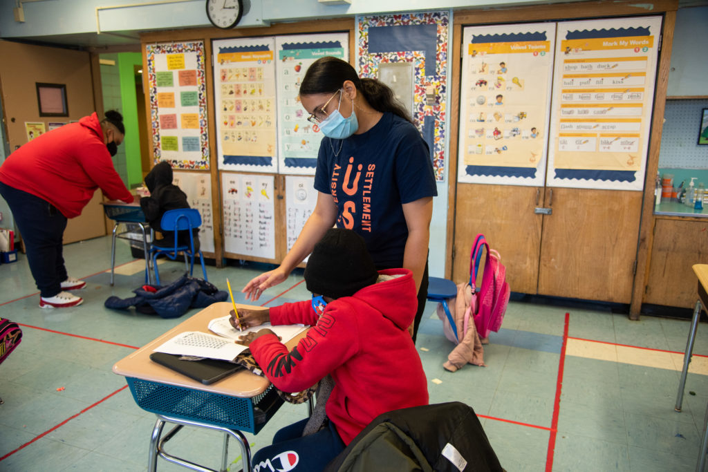 Children receiving tutoring from US staff